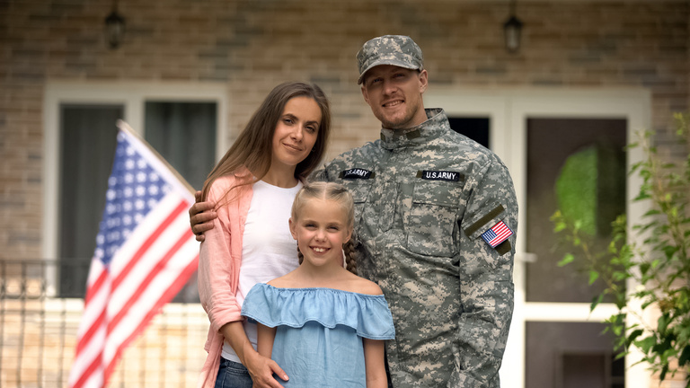 Happy american patriots family looking at camera, social insurance for veterans